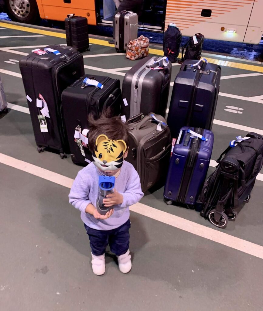 My kid with our luggage in the background. Imaging carrying all that on a train?