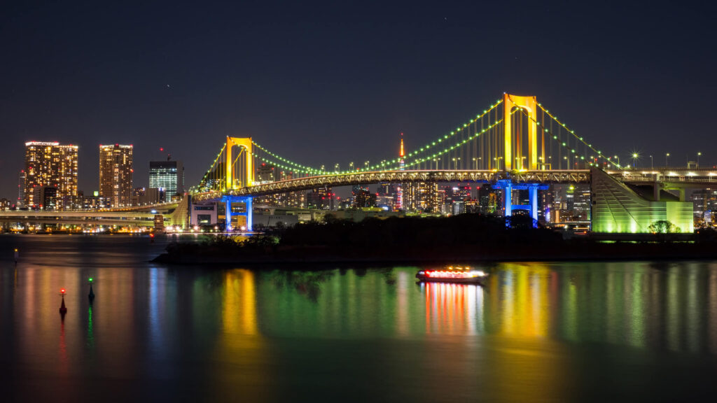 View from Odaiba, of illuminated Rainbow Bridge, with Tokyo Tower in the background