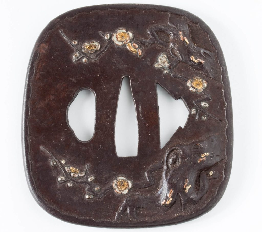 Tsuba (sword hand guard) decorated with intricate sakura (cherry blossom)